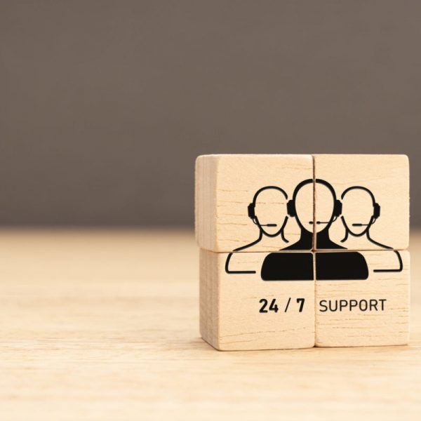 24-7 Customer support concept. Group of wooden block with Group of Call Center Workers icon. Copy space